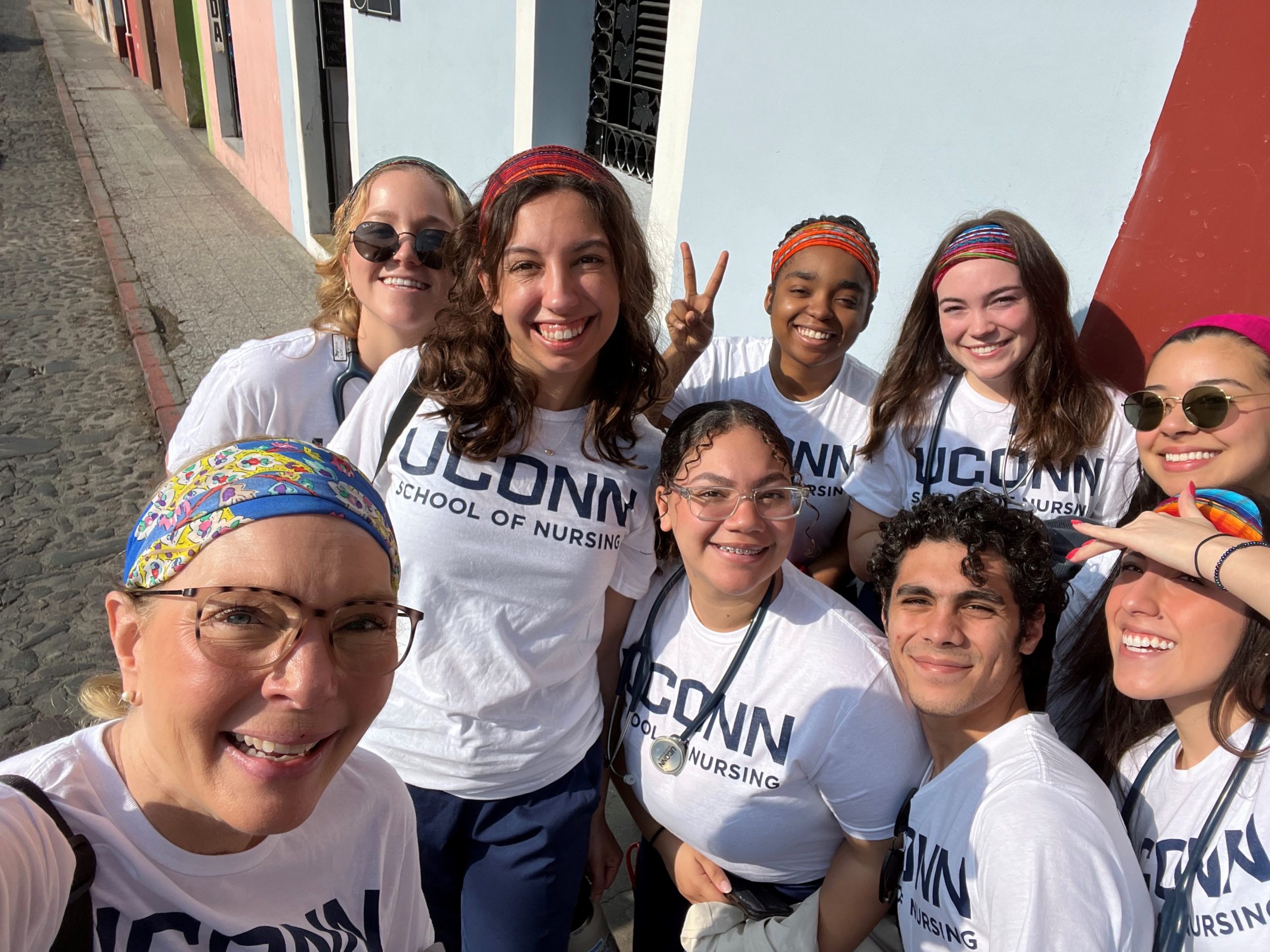 Nursing professor Michelle Cole stands in front of a group fo UConn students in Guatemala