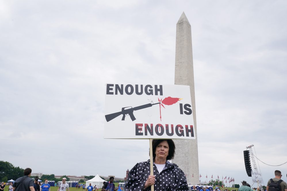 Participants hold signs during the March for Our Lives 2022 on June 11, 2022 in Washington, DC. (Photo by Leigh Vogel/Getty Images)
